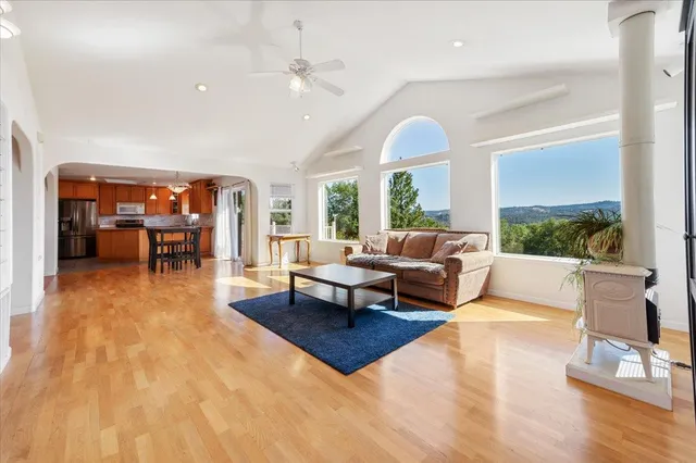 a living room with furniture and wooden floor