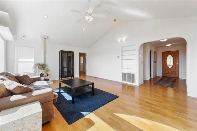 a kitchen with stainless steel appliances granite countertop a stove top oven a sink with island and chairs