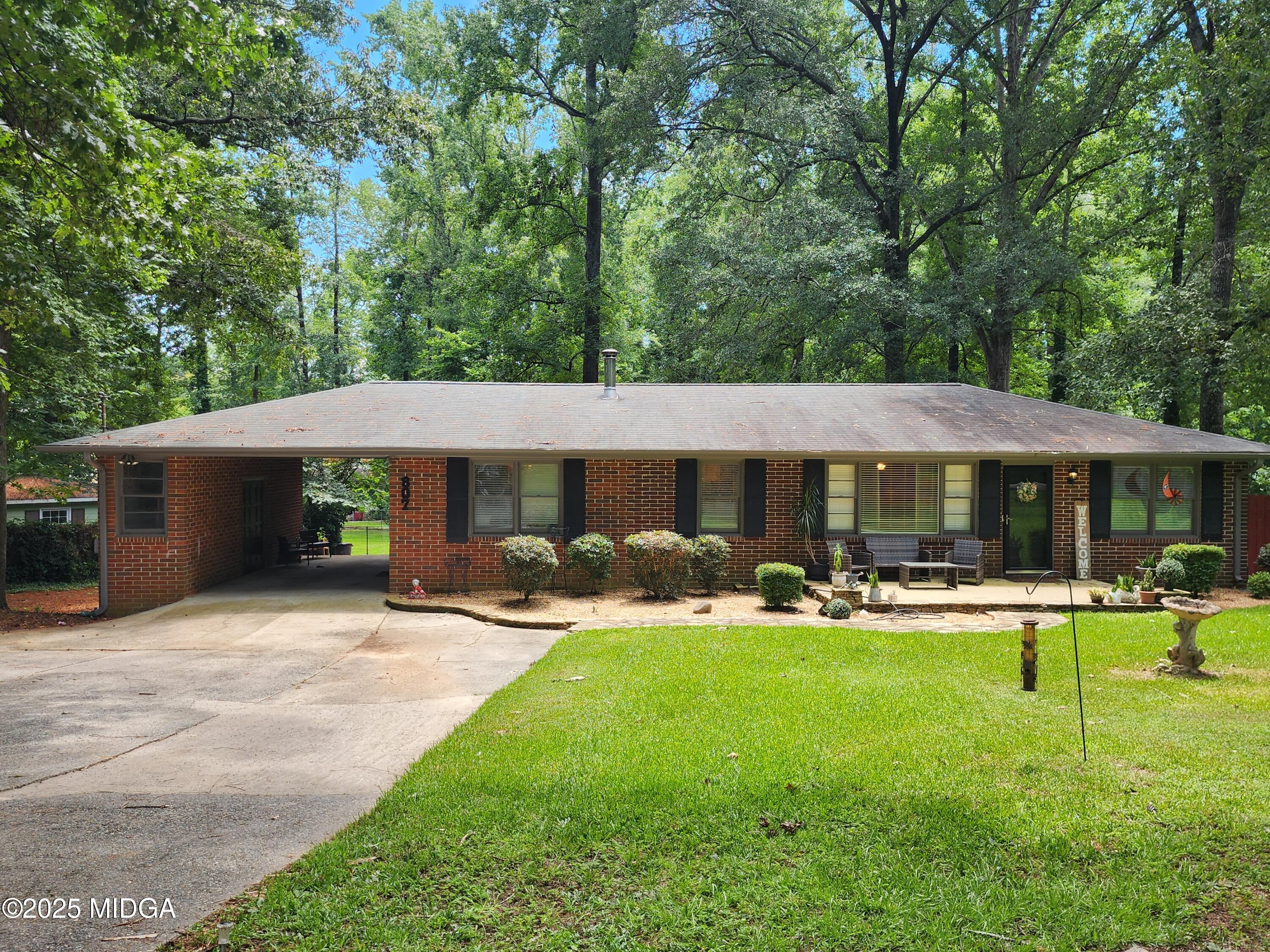 807 Wera Place Macon, GA 31210 - Photo 1 of 42 a backyard of a house with garden and outdoor seating