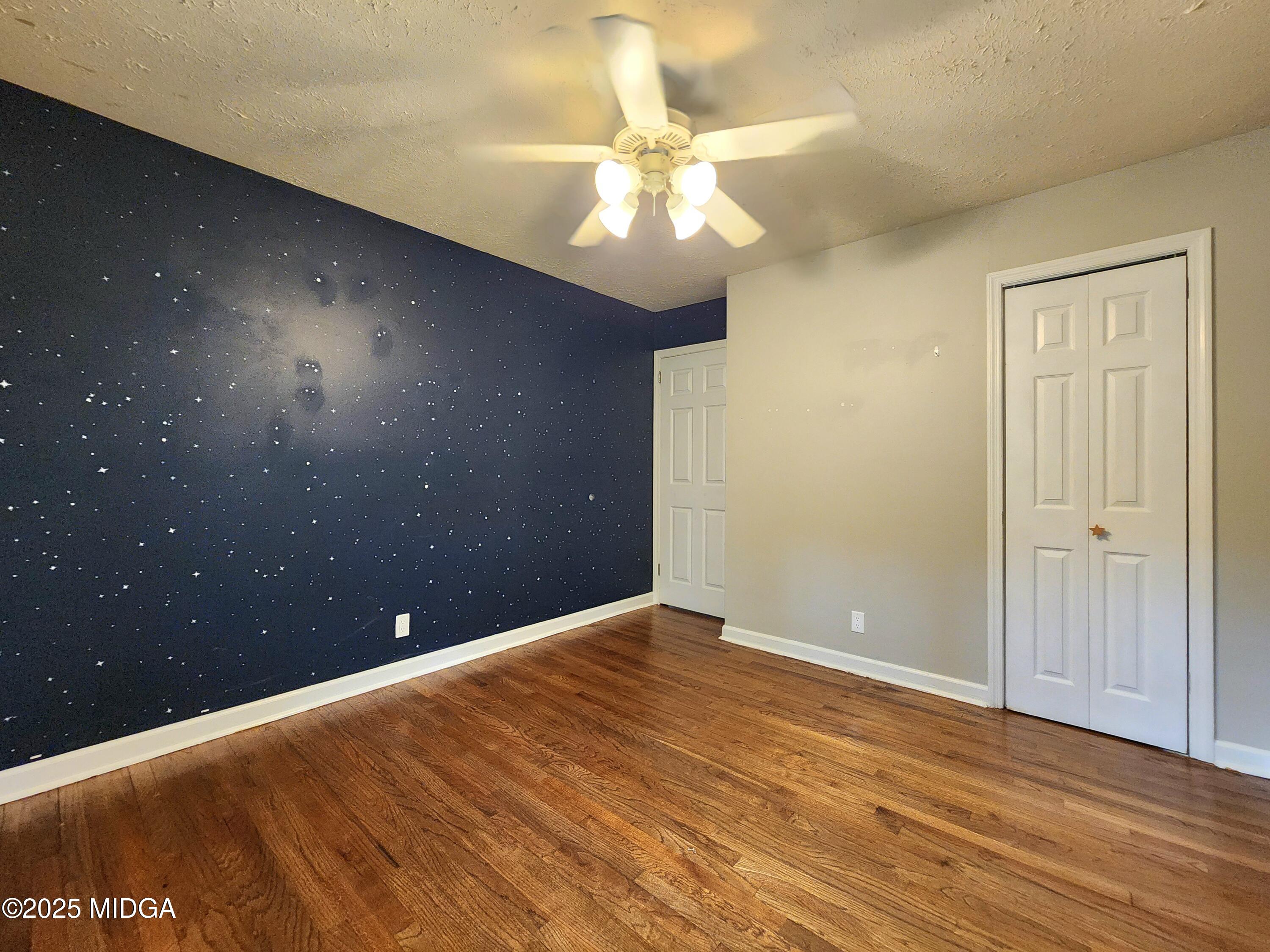 807 Wera Place Macon, GA 31210 - Photo 12 of 42 wooden floor in an empty room with a window