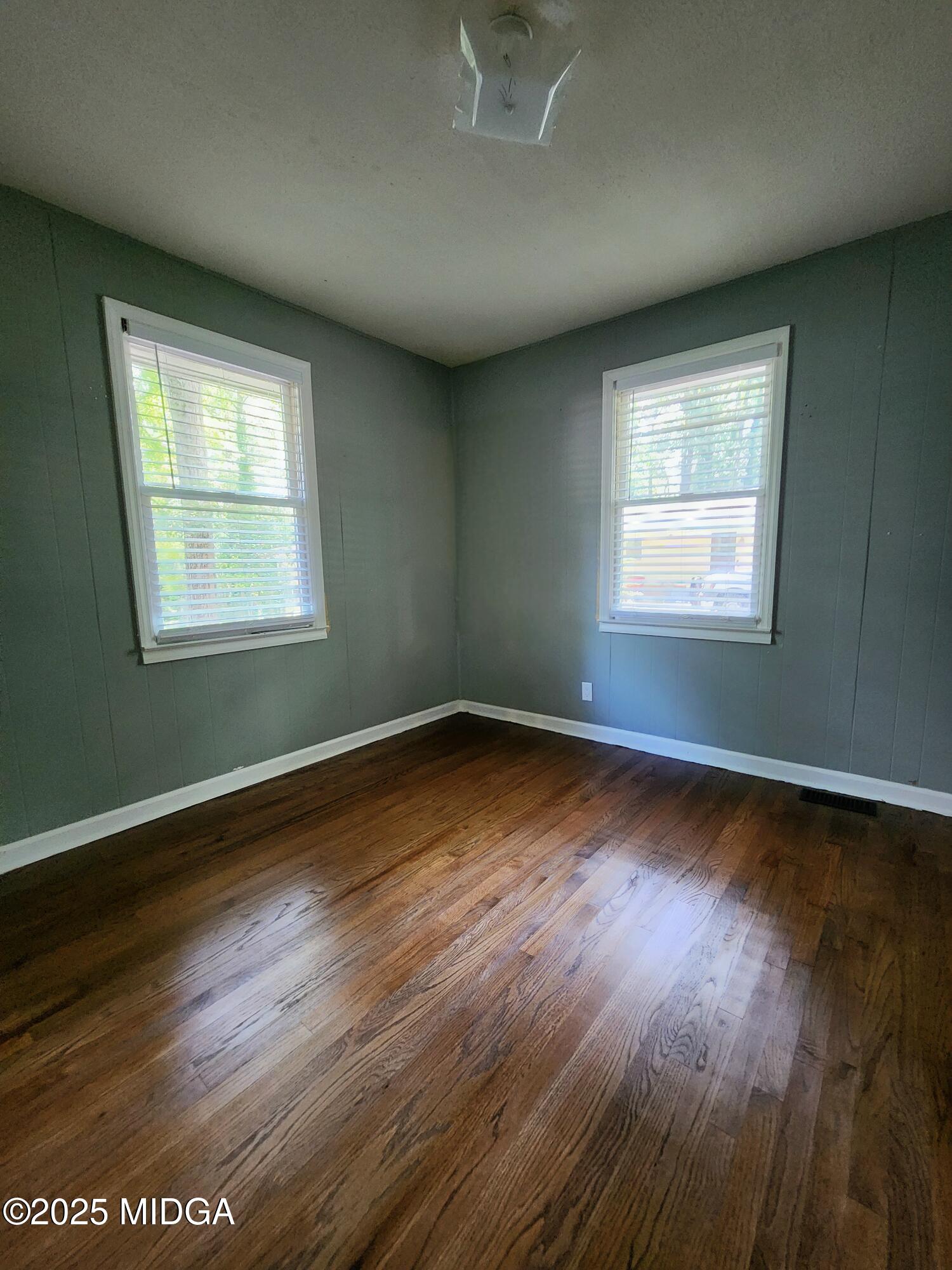 807 Wera Place Macon, GA 31210 - Photo 13 of 42 an empty room with wooden floor and windows