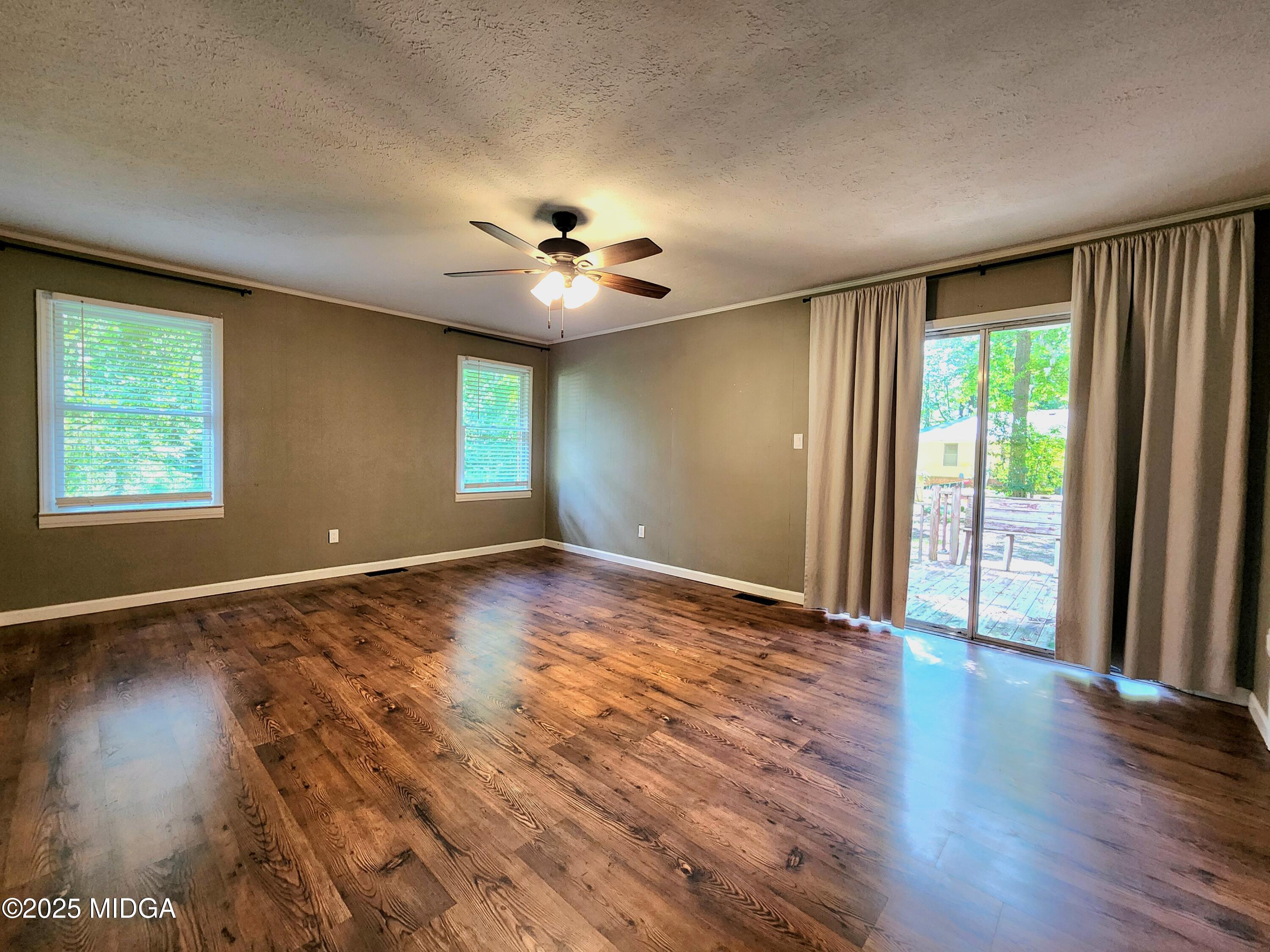 807 Wera Place Macon, GA 31210 - Photo 18 of 42 a view of an empty room with wooden floor and a window