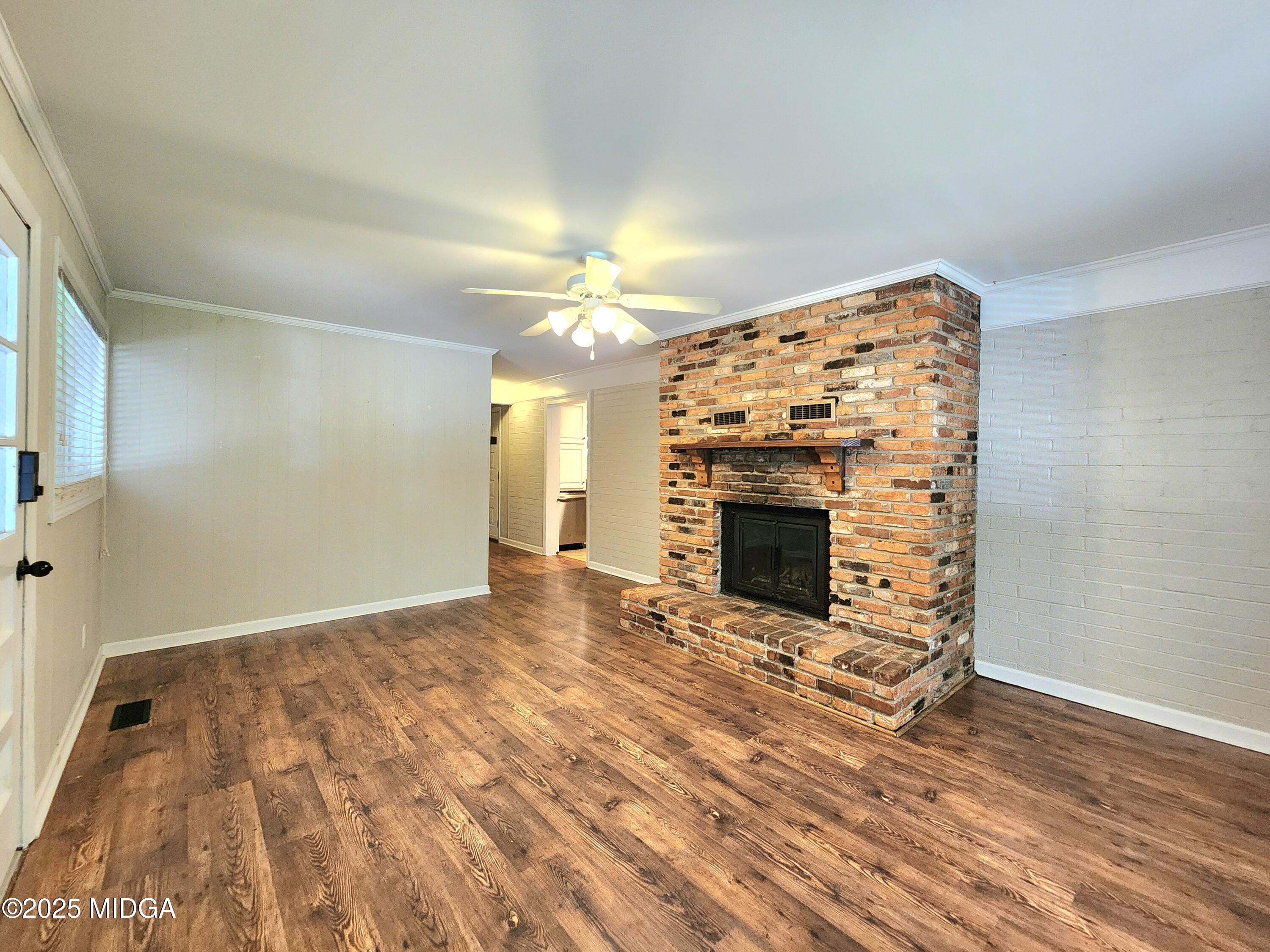 807 Wera Place Macon, GA 31210 - Photo 21 of 42 a view of an empty room with wooden floor fireplace and a window