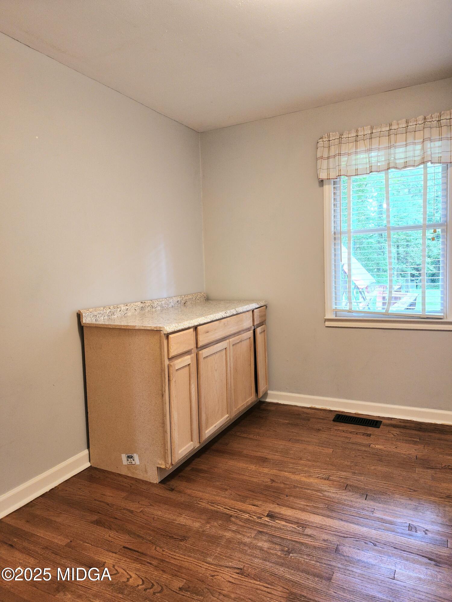 807 Wera Place Macon, GA 31210 - Photo 27 of 42 a view of an empty room with wooden floor and a window