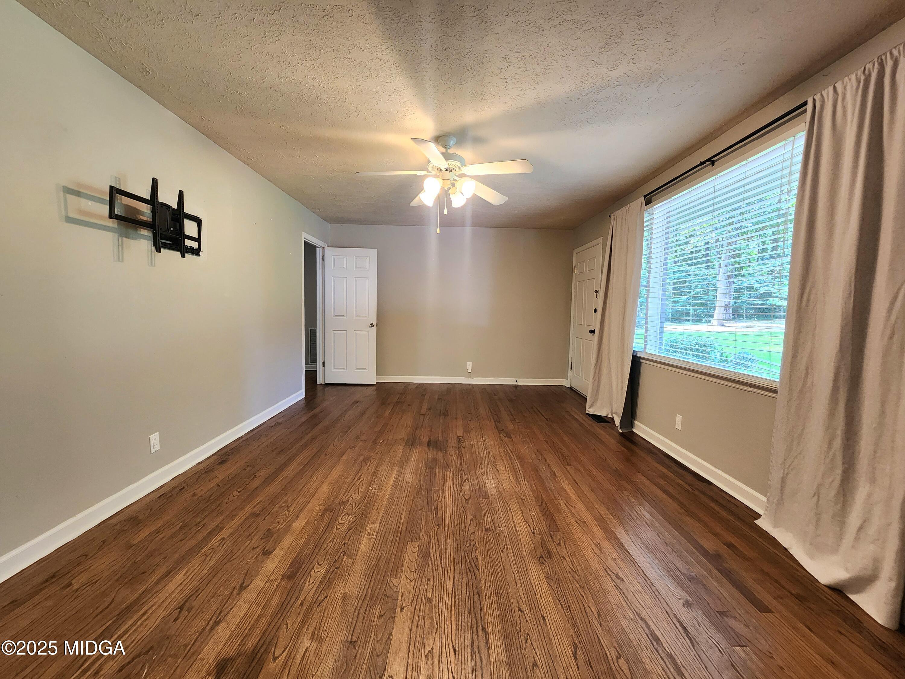 807 Wera Place Macon, GA 31210 - Photo 9 of 42 wooden floor in an empty room with a window