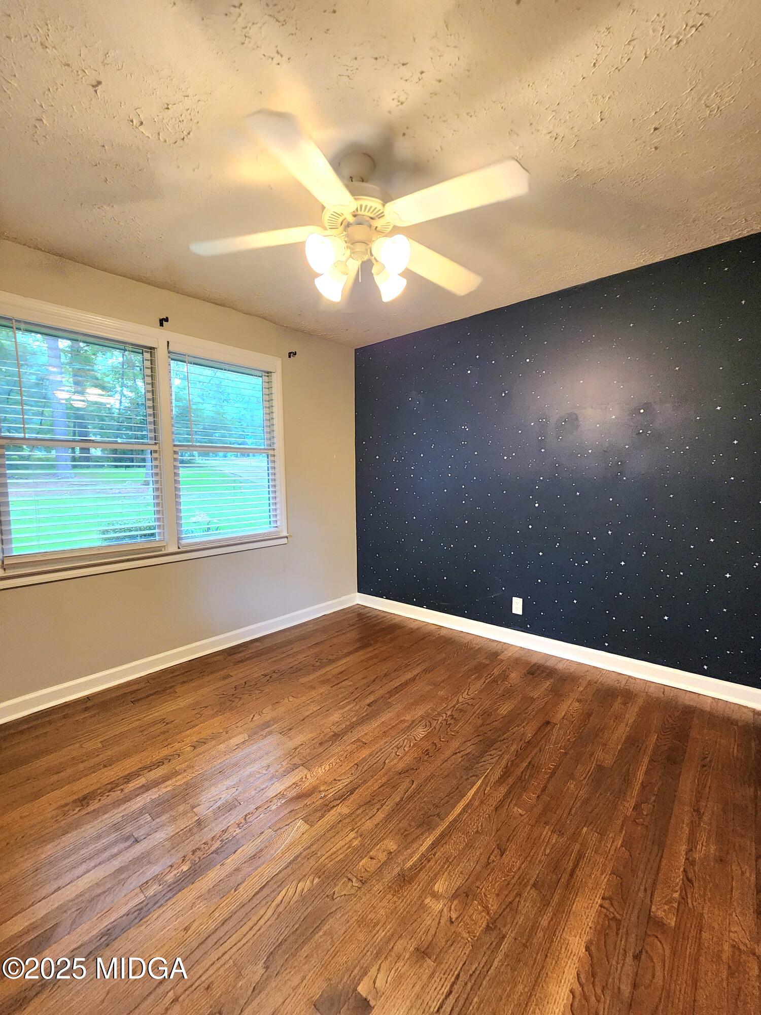 807 Wera Place Macon, GA 31210 - Photo 10 of 42 a view of an empty room with wooden floor and a window