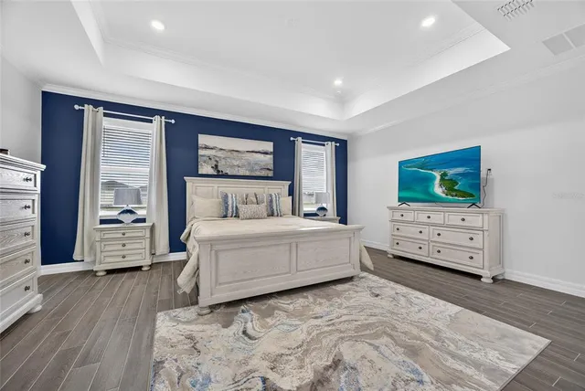 a large white bathroom with a double vanity sink a mirror and a bathtub