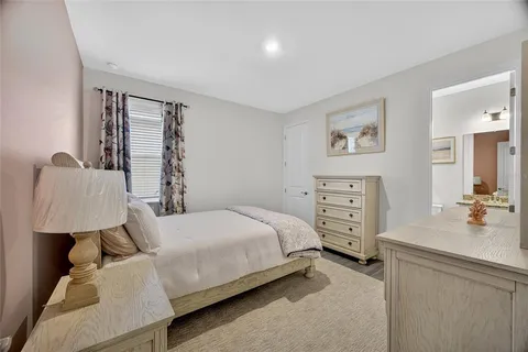 a room with a bed and a dresser