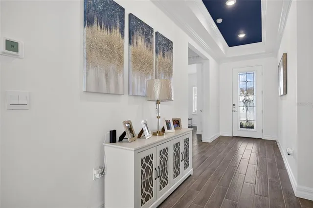 a room with stainless steel appliances kitchen island granite countertop a dining table chairs and view of living room