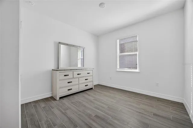 a view of a room with wooden floor and cabinet