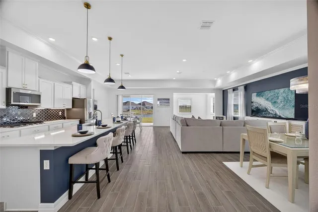 a living room with furniture and kitchen view