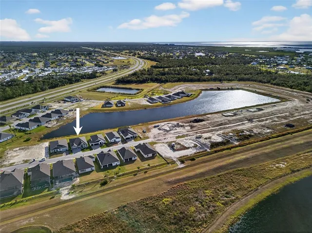 a view of a house and a yard and a street