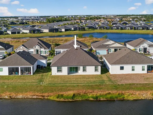 an aerial view of a house with a yard pool outdoor seating and yard