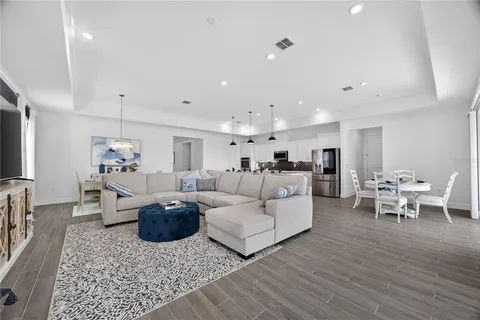 a kitchen with stainless steel appliances granite countertop a sink a stove a refrigerator and island