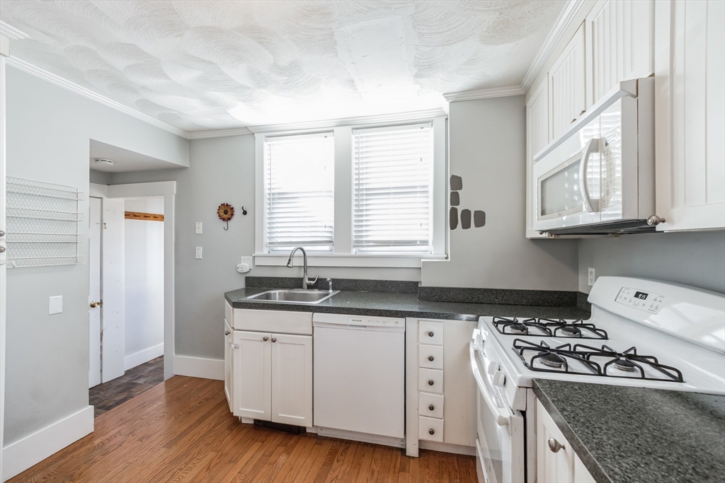 801 Boston Road Billerica, MA 01821 - Photo 3 of 29 a kitchen with granite countertop a sink a stove and cabinets