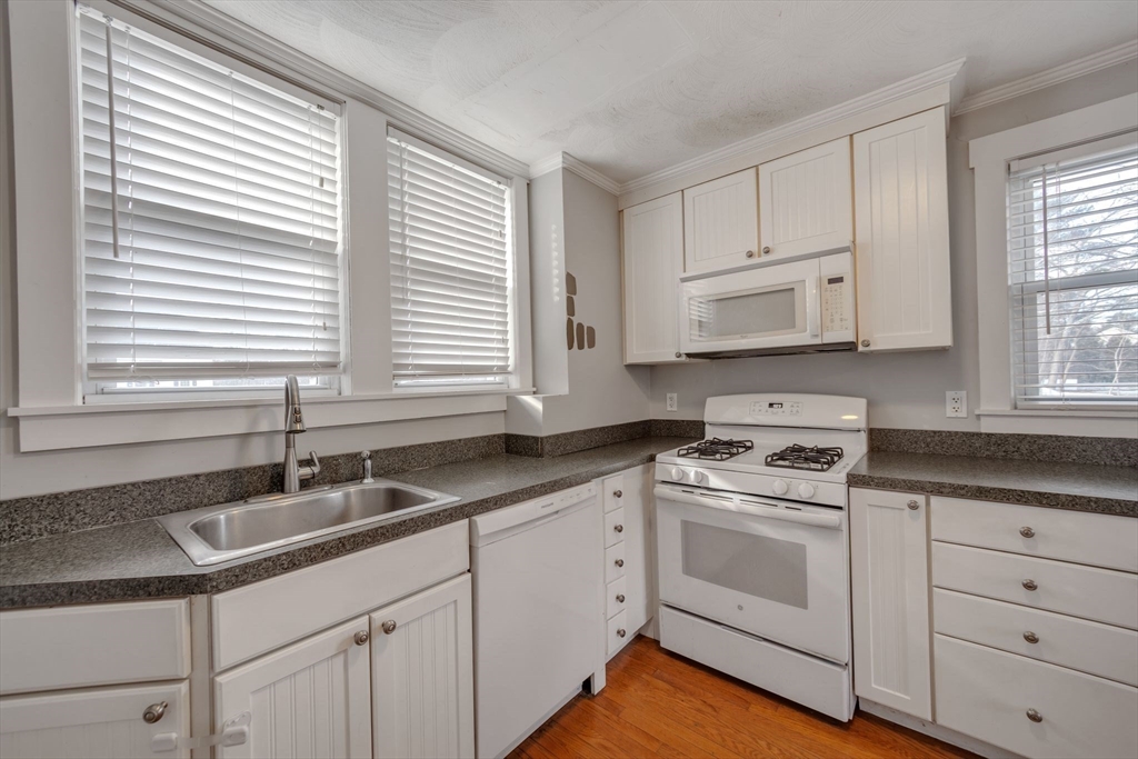 801 Boston Road Billerica, MA 01821 - Photo 4 of 29 a kitchen with white cabinets and white appliances
