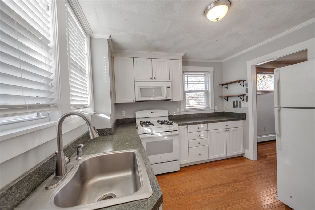 801 Boston Road Billerica, MA 01821 - Photo 5 of 29 a kitchen with white cabinets and sink