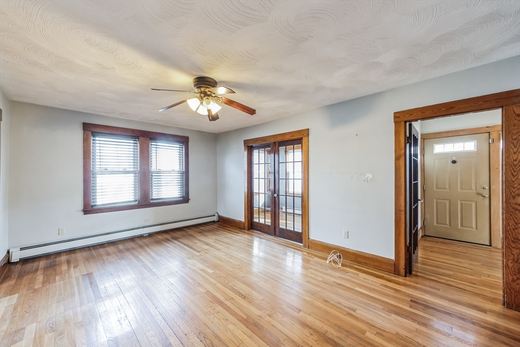 801 Boston Road Billerica, MA 01821 - Photo 8 of 29 a view of an empty room with wooden floor and a window