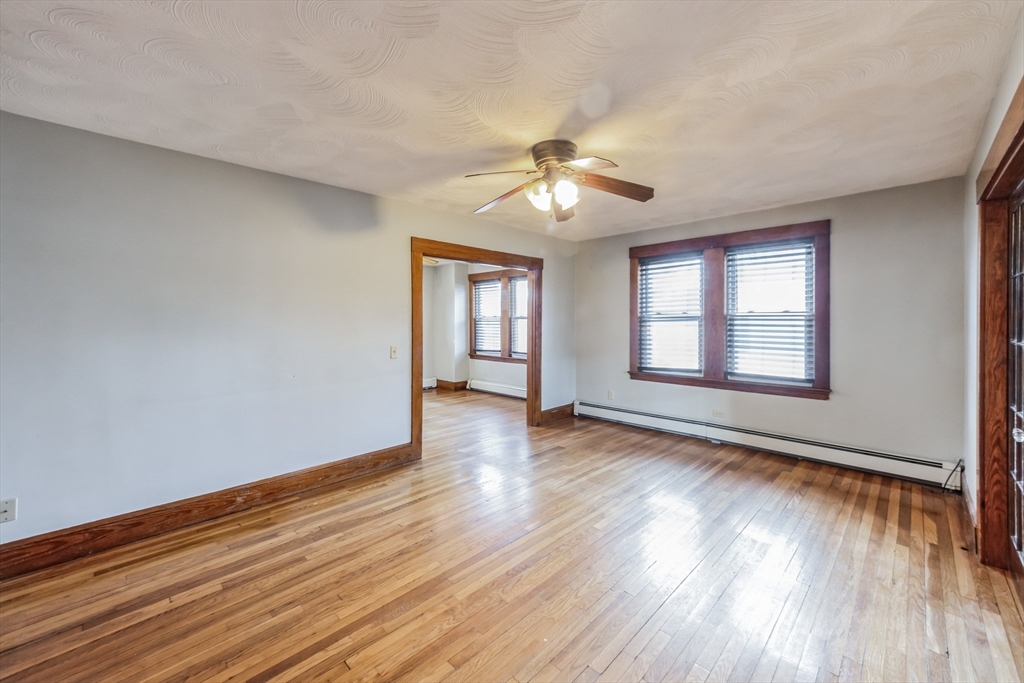 801 Boston Road Billerica, MA 01821 - Photo 9 of 29 a view of an empty room with wooden floor and a window