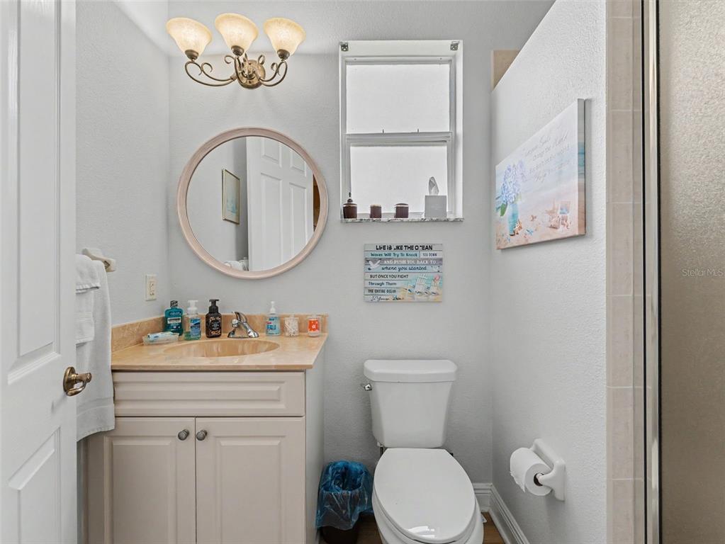 8910 Jericho Road Weeki Wachee, FL 34613 - Photo 30 of 52 a bathroom with a toilet a sink and a mirror