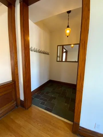 a view of a hallway with wooden floor