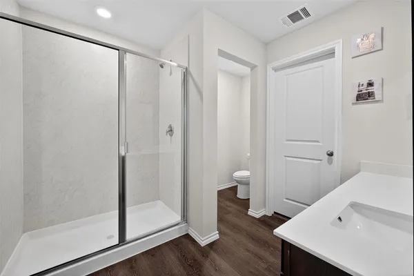 a bathroom with a shower and a sink
