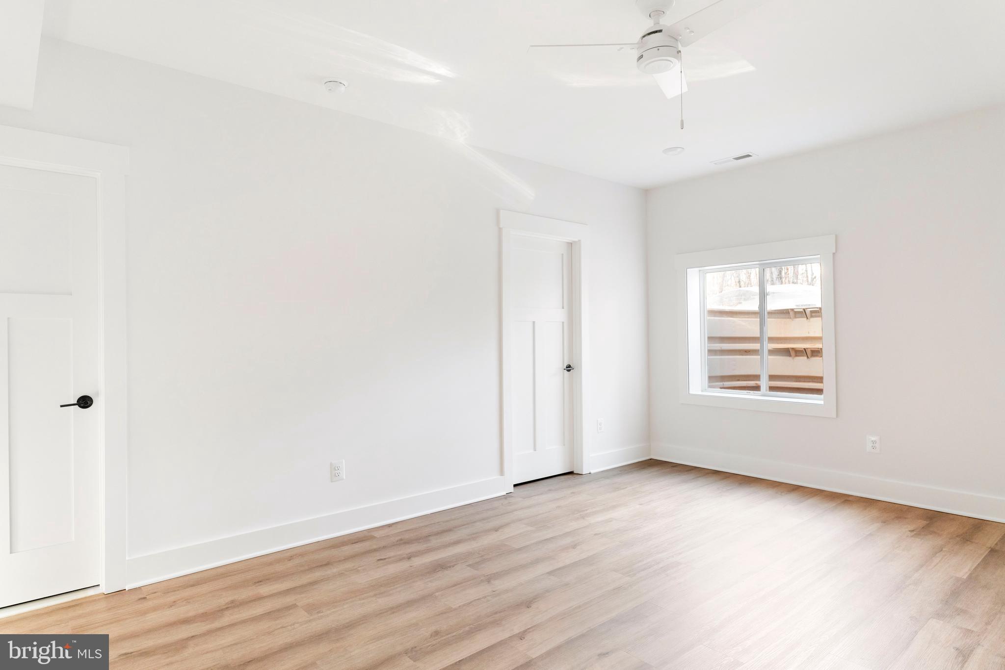 3321 Patuxent River Road Davidsonville, MD 21035 - Photo 62 of 81 an empty room with wooden floor and windows