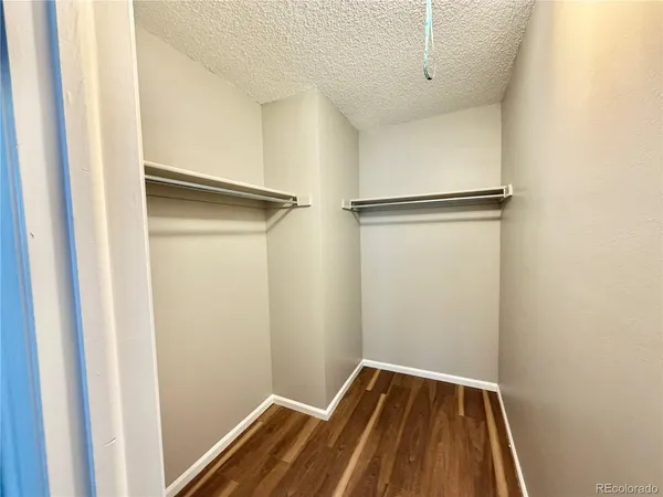 a view of walk in closet with empty racks