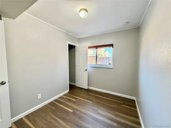 a view of room with window and wooden floor