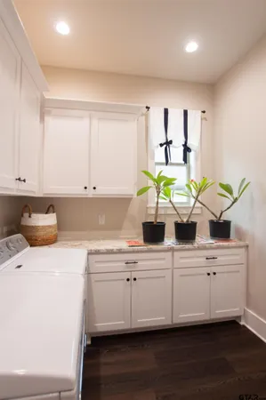 a kitchen with kitchen island white cabinets and a sink