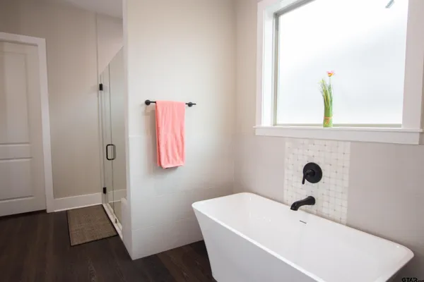 a bathroom with a tub and a window