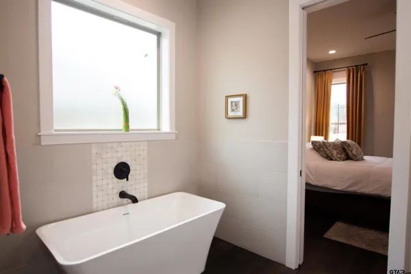 a bathroom with a tub and a window