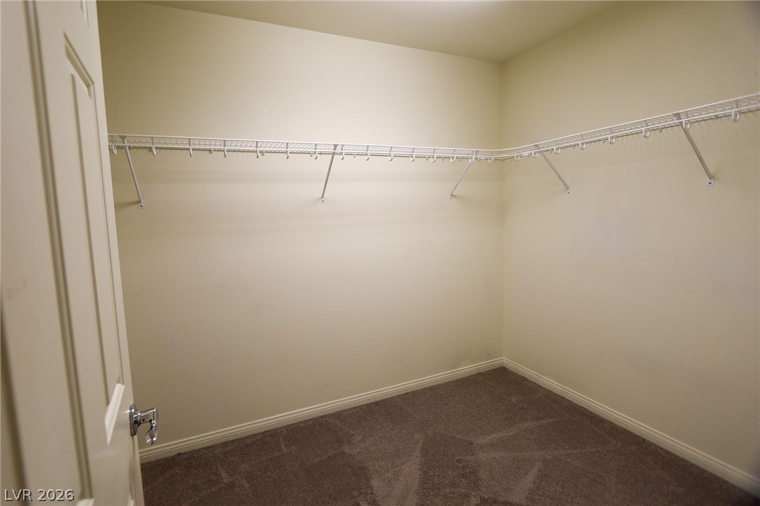 6418 Jackson Spring Road Las Vegas, NV 89118 - Photo 17 of 20 A spacious walk-in closet with extensive wire shelving offers abundant storage potential.