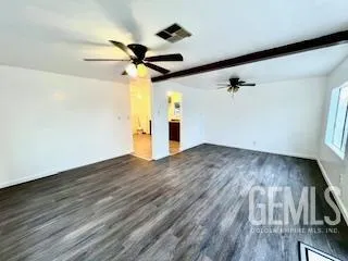 a view of a room with wooden floor