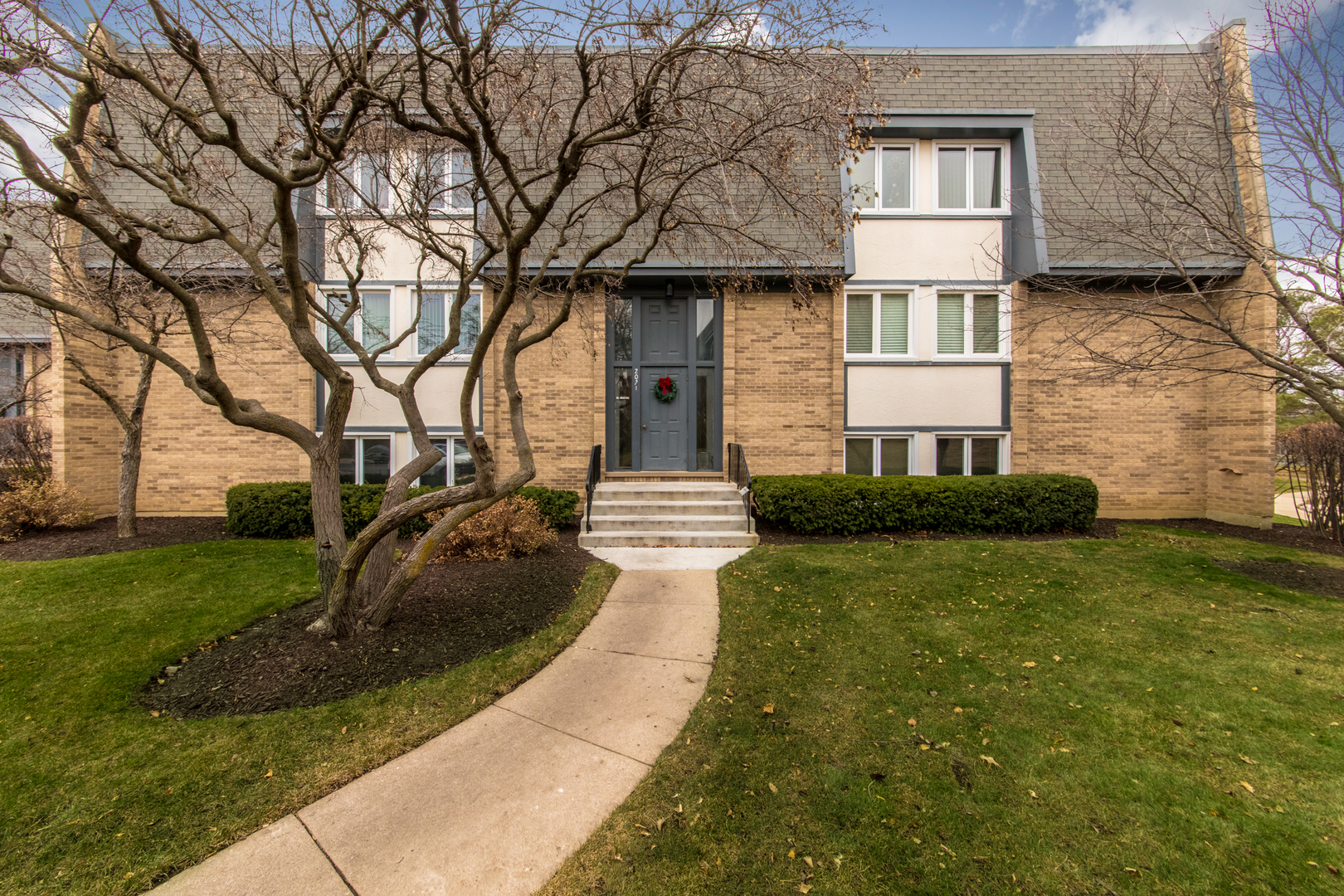2021 Ammer Ridge Court, Unit 202 Glenview, IL 60025 - Photo 1 of 24 a front view of a house with garden