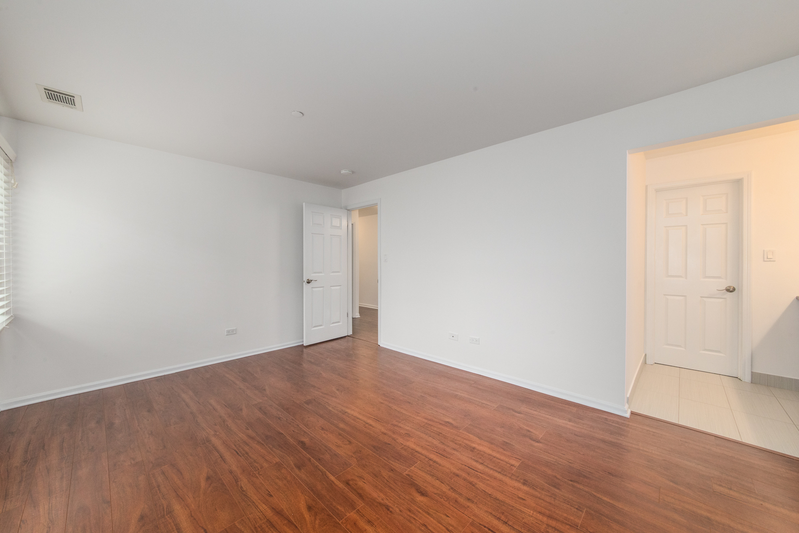 2021 Ammer Ridge Court, Unit 202 Glenview, IL 60025 - Photo 13 of 24 a view of an empty room with wooden floor