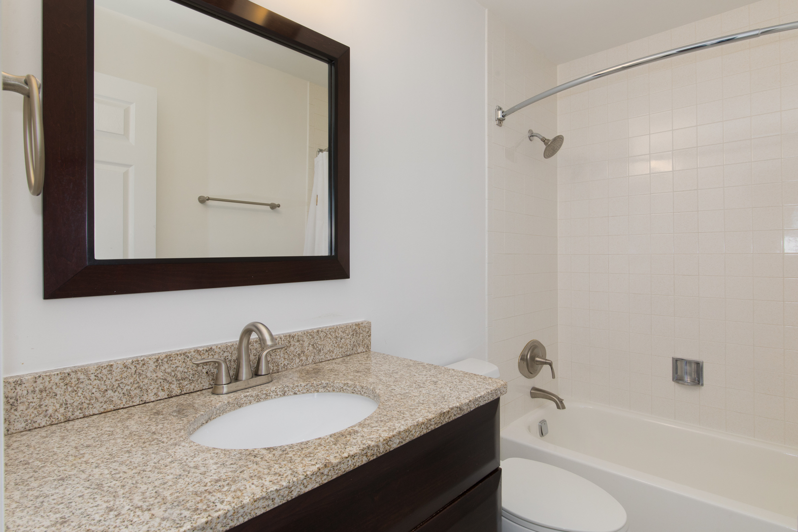 2021 Ammer Ridge Court, Unit 202 Glenview, IL 60025 - Photo 16 of 24 a bathroom with a granite countertop sink mirror toilet and bathtub