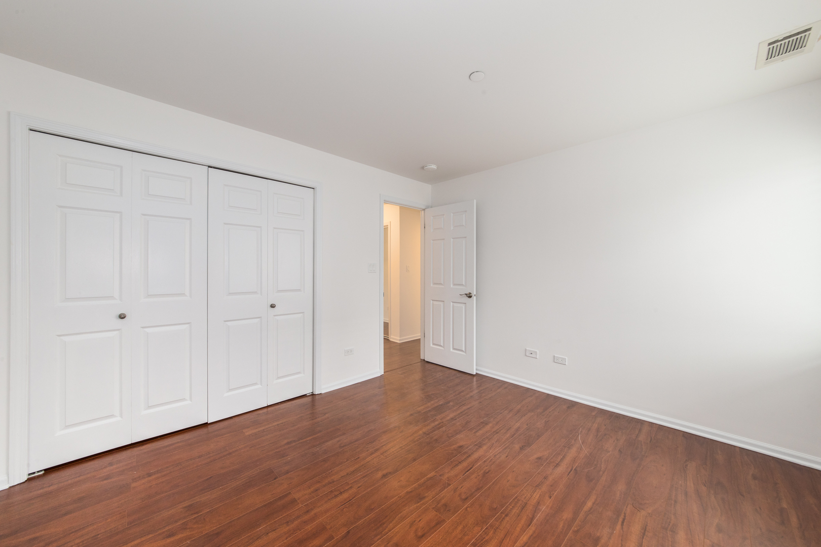 2021 Ammer Ridge Court, Unit 202 Glenview, IL 60025 - Photo 18 of 24 a view of an empty room with wooden floor
