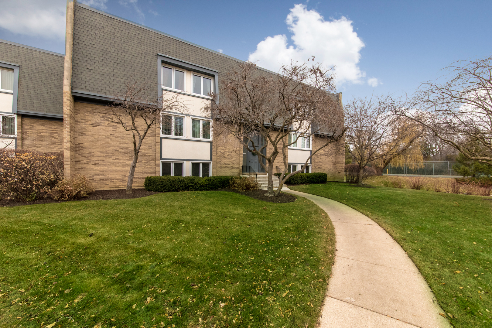 2021 Ammer Ridge Court, Unit 202 Glenview, IL 60025 - Photo 22 of 24 a front view of a house with a garden