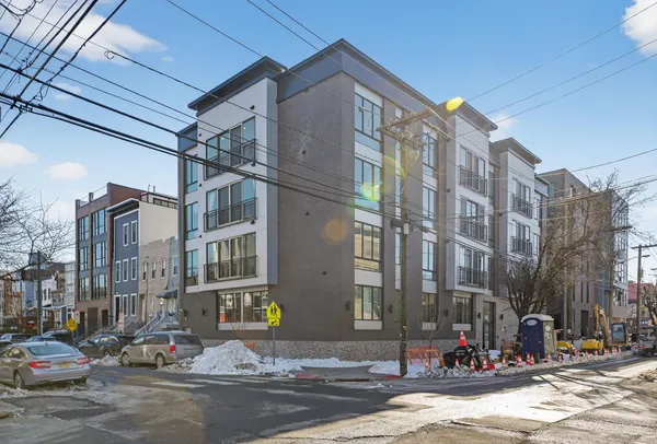 a city street lined with buildings and cars on road