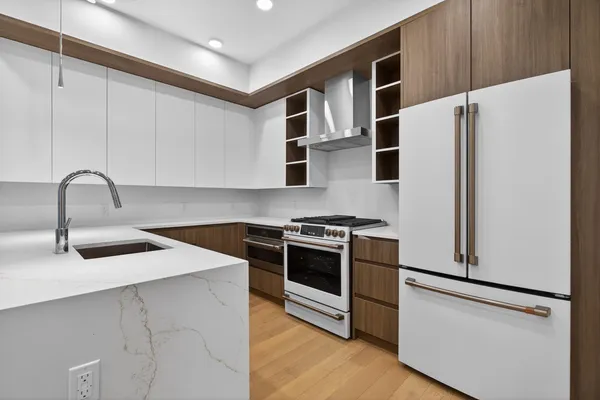 a kitchen with stainless steel appliances a refrigerator and a sink