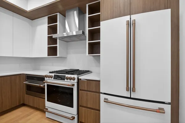 a kitchen with stainless steel appliances granite countertop a refrigerator and a stove
