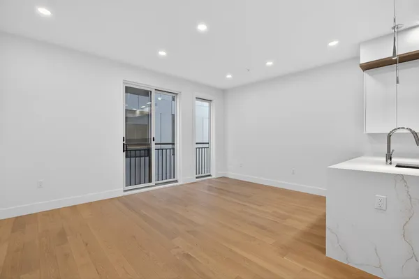 a view of a kitchen with a sink and a refrigerator