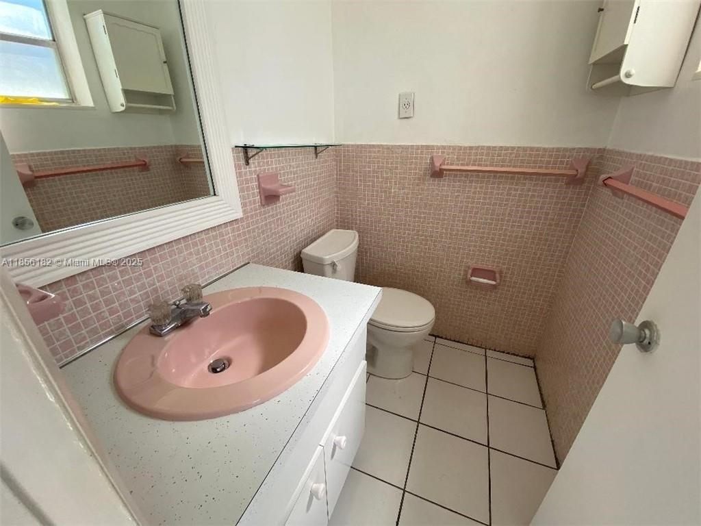 1855 Plunkett Street, Unit 101 Hollywood, FL 33020 - Photo 15 of 24 a bathroom with a sink and toilet