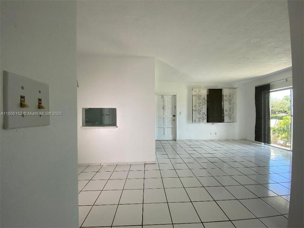 1855 Plunkett Street, Unit 101 Hollywood, FL 33020 - Photo 4 of 24 a view of an empty room and window