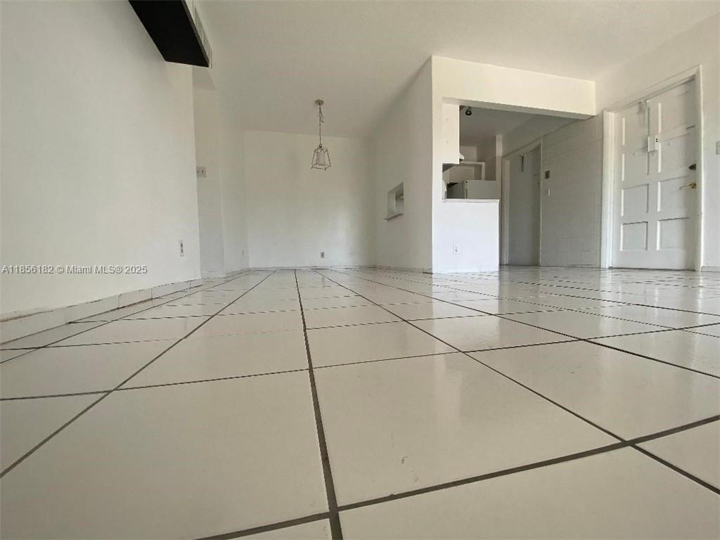 1855 Plunkett Street, Unit 101 Hollywood, FL 33020 - Photo 6 of 24 a view of an empty room with a bathroom
