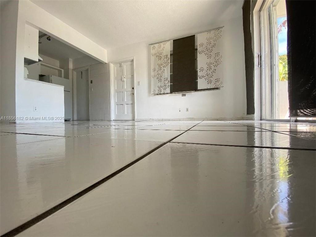 1855 Plunkett Street, Unit 101 Hollywood, FL 33020 - Photo 7 of 24 a view of a living room with a large window