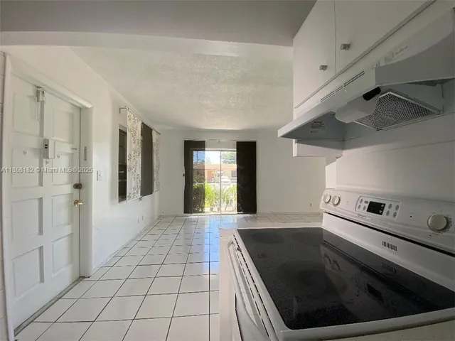 a kitchen with a stove and a refrigerator