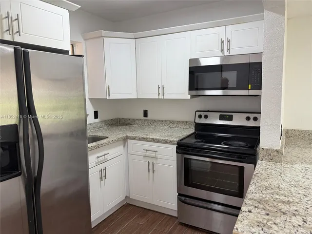 a kitchen with a stove and a microwave