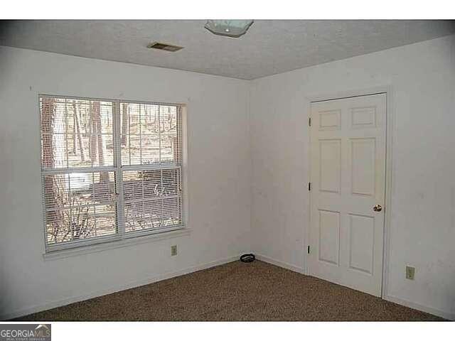 771 Farm Creek Road Northeast Woodstock, GA 30188 - Photo 13 of 14 a view of an empty room with a window